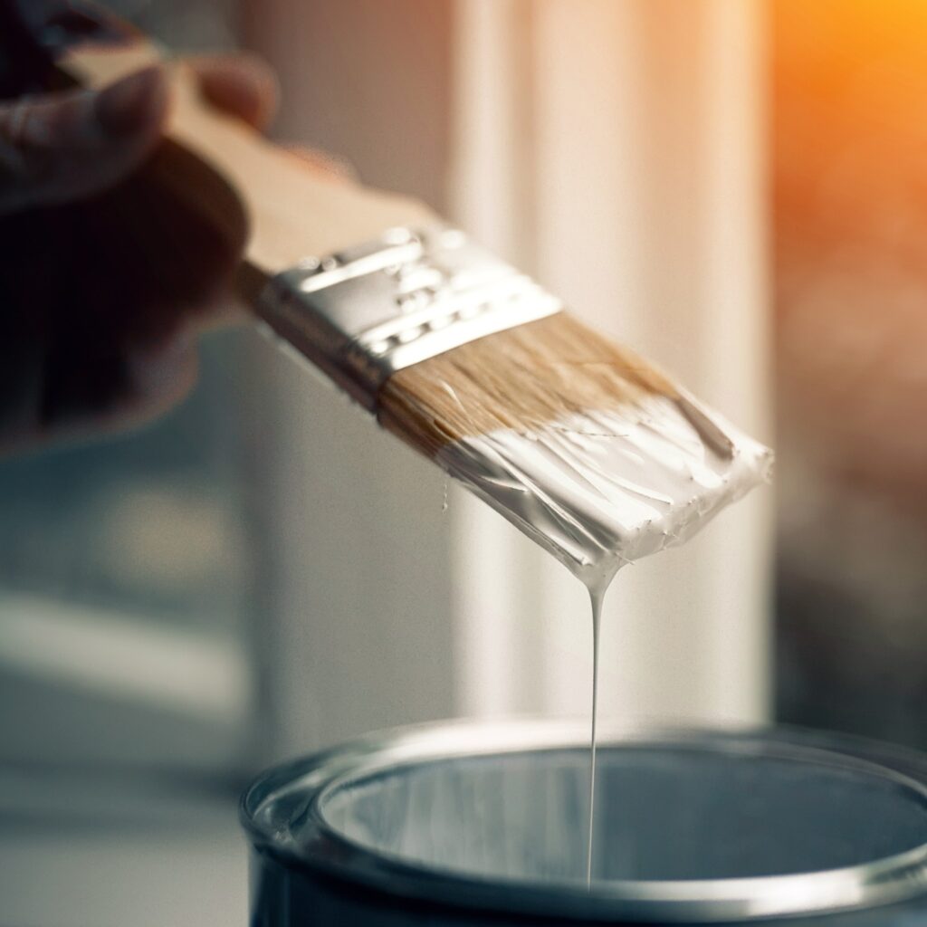 Brush in white paint.