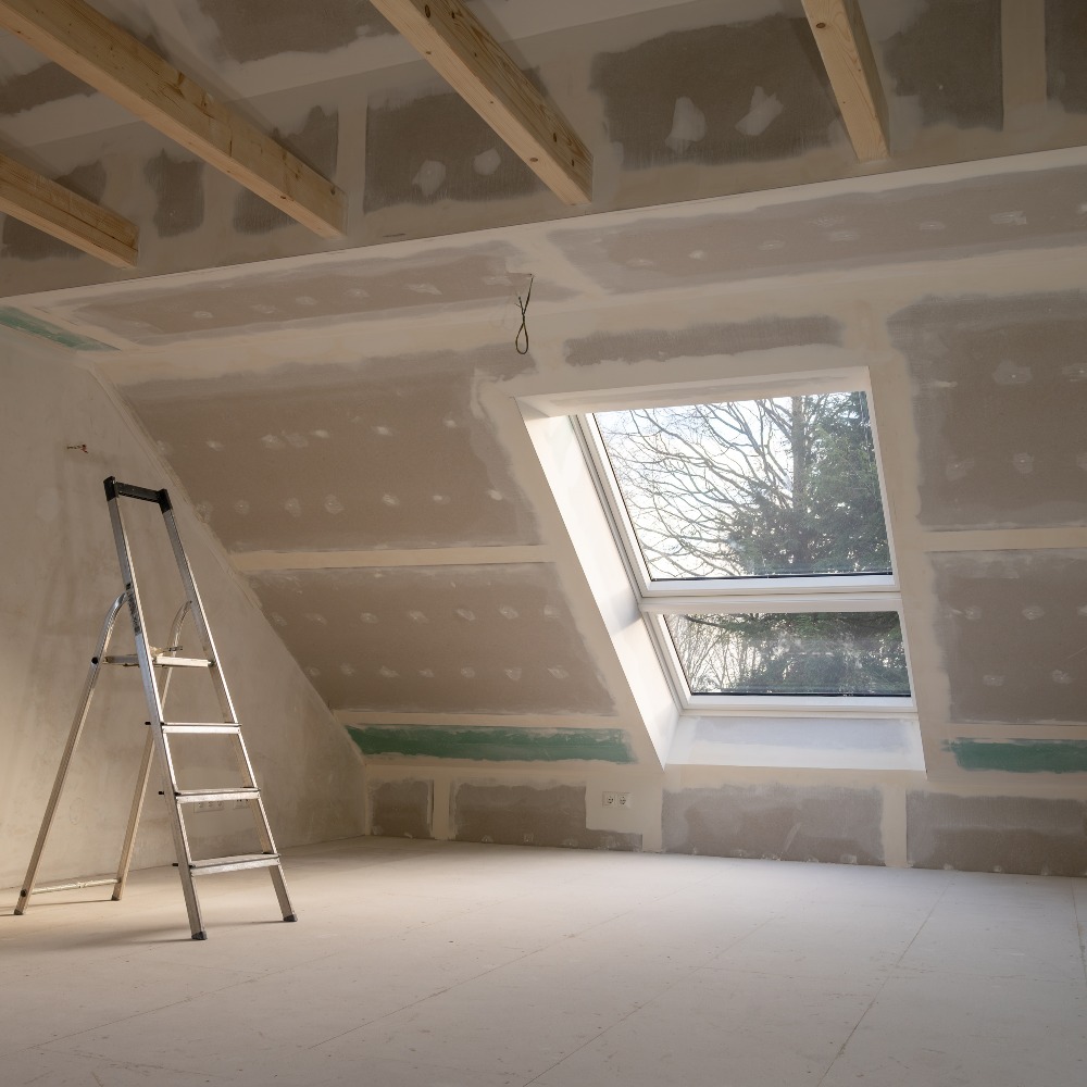 Renovation in a private house. Plastering drywalls in the attic.